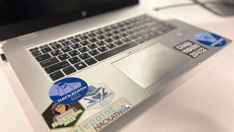 Desktop with Hackathon stickers