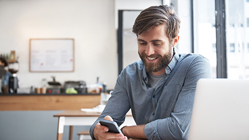 Man smiling at his phone