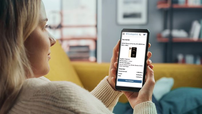 claimshop-settlement-customer-journey-mobile-screen_706x397 Woman looking for phone in product catalogue on her mobile phone